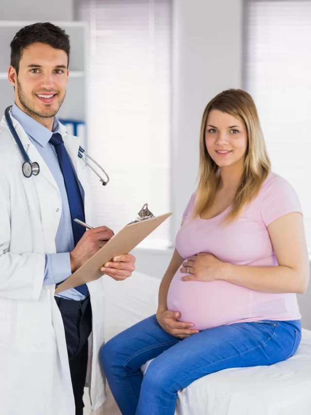 portrait-smiling-doctor-his-pregnant-patient